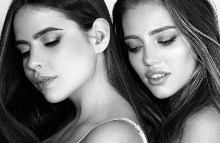 Portrait of two cheerful young women. Two beautiful young women with perfect skin in the studio. Lesbians lgbt couple. Natural beauty and skincare concept. Cosmetics and makeup